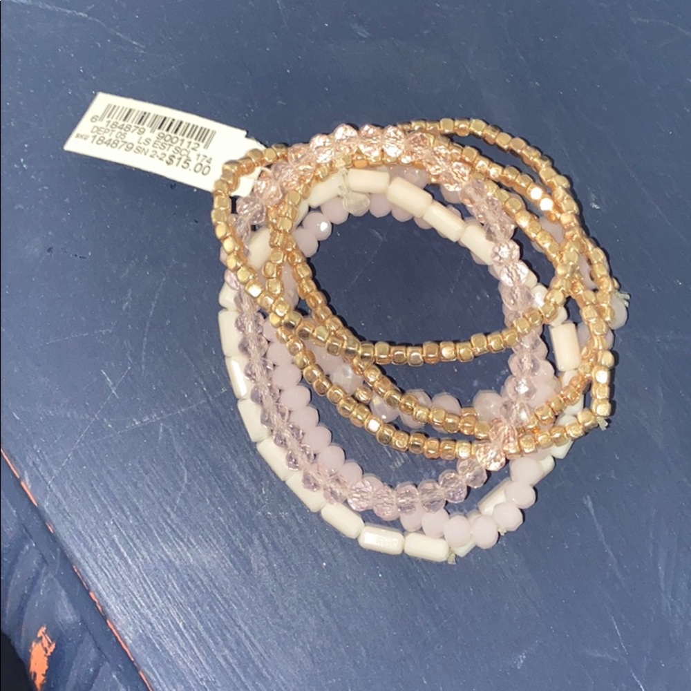 Set of seven pink and gold bracelets
